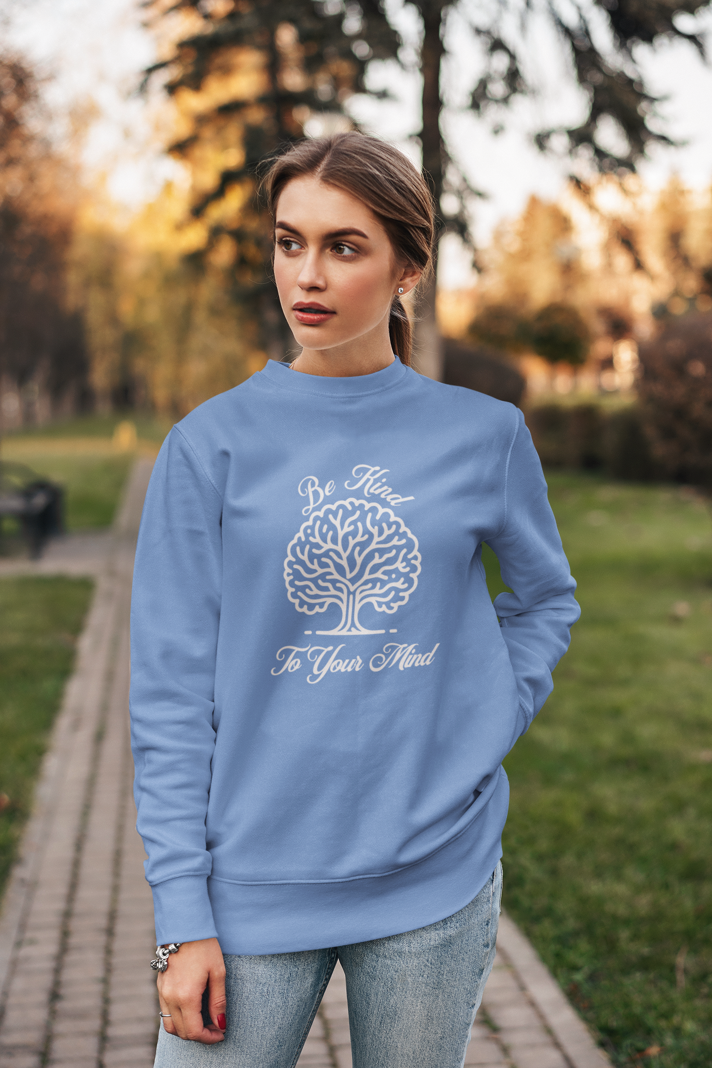 crewneck-sweatshirt-of-a-serious-woman-posing-in-a-garden-wearing-be-kind-to-your-mind-shirt-blue
