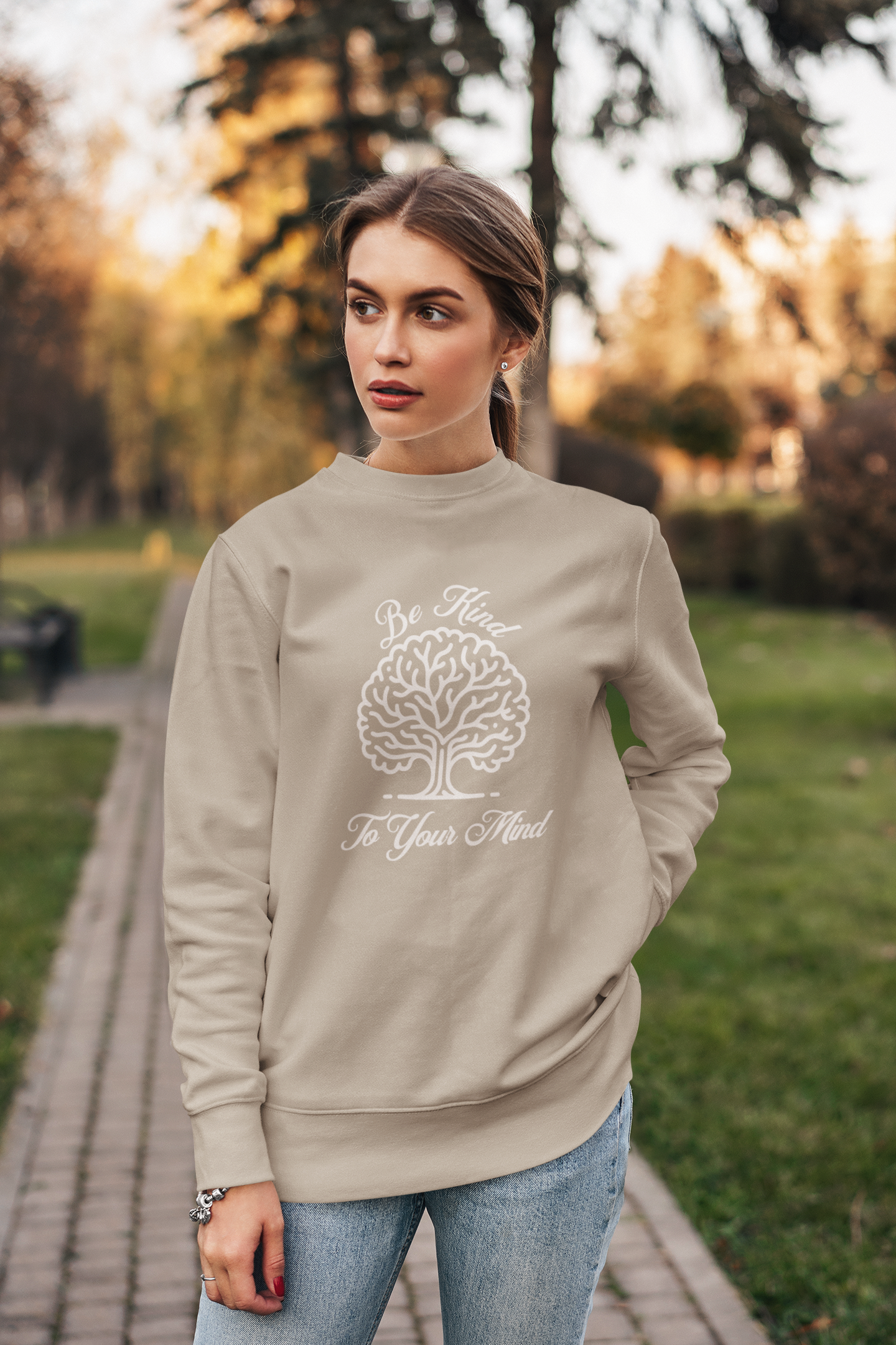 crewneck-sweatshirt-of-a-serious-woman-posing-in-a-garden-wearing-be-kind-to-your-mind-shirt-sand
