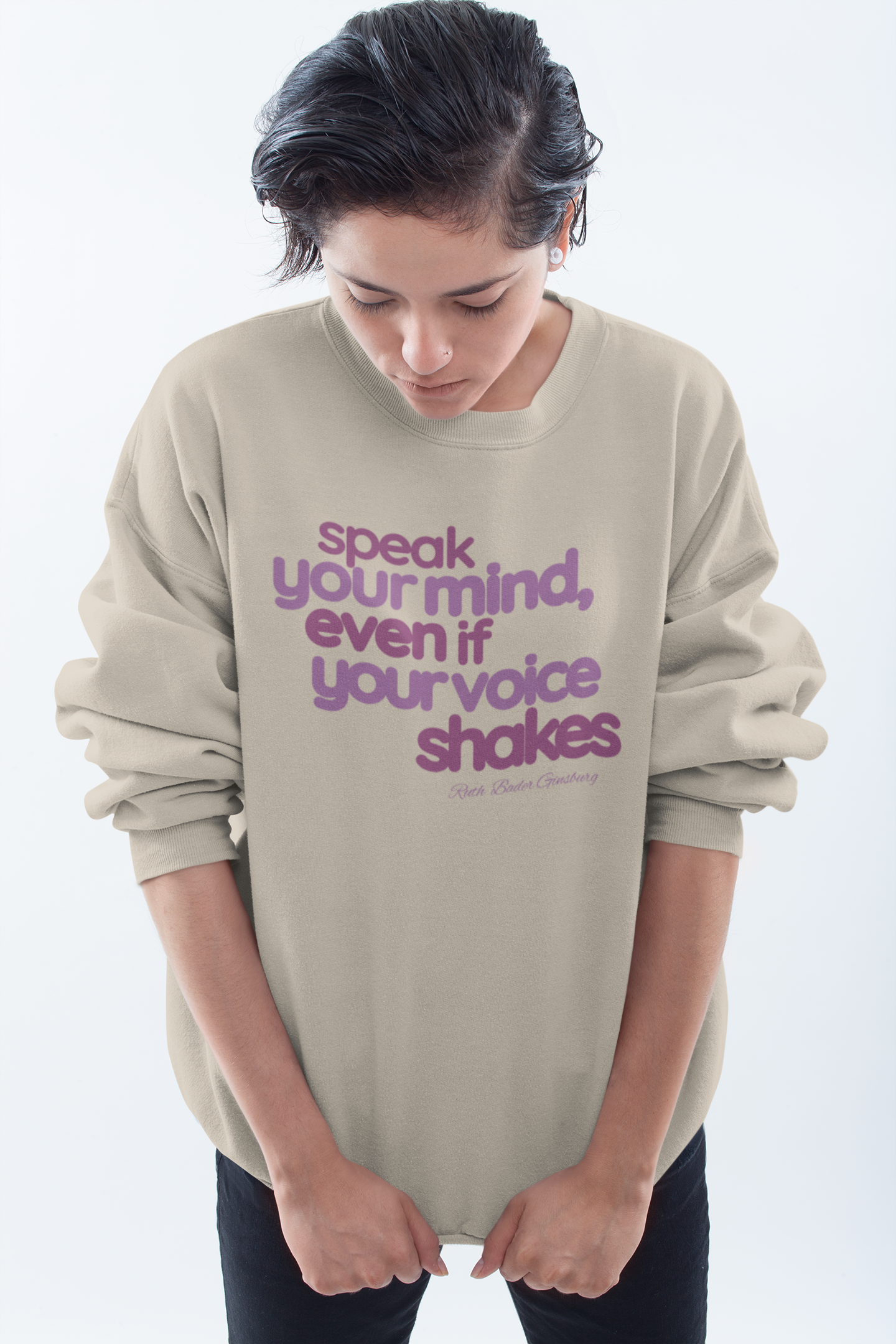 short-haired-woman-pulling-down-her-sweatshirt-wearing-women-empoowerment-shirt-sand