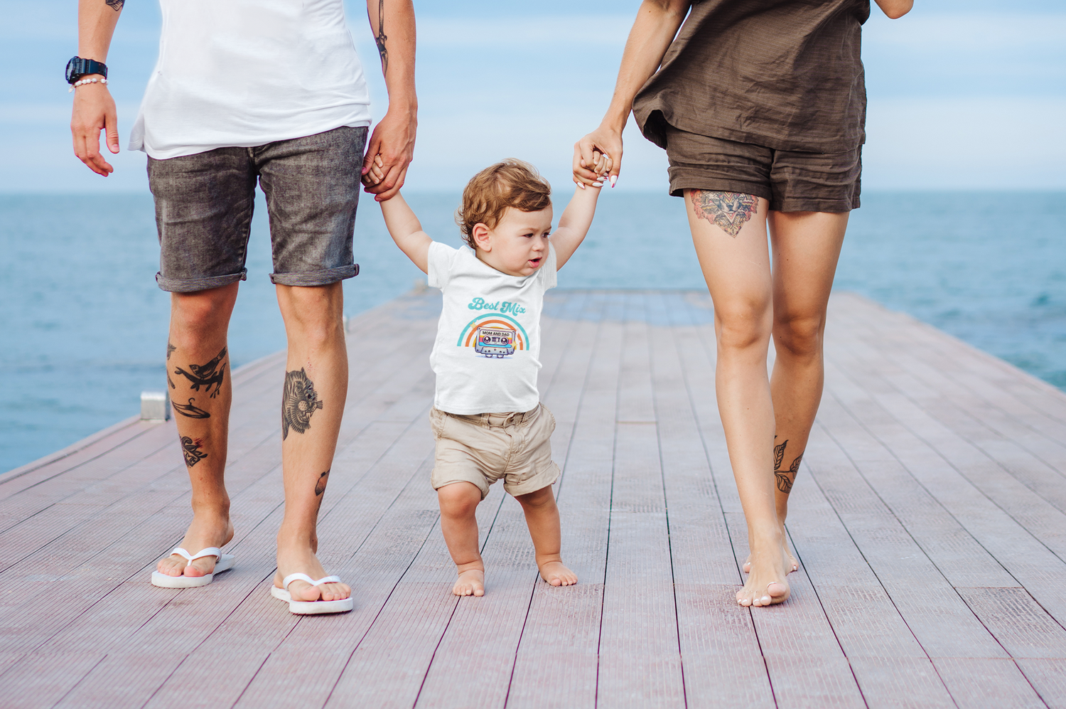 t-shirt-mockup-of-a-baby-boy-taking-his-first-steps-with-mom-and-dad