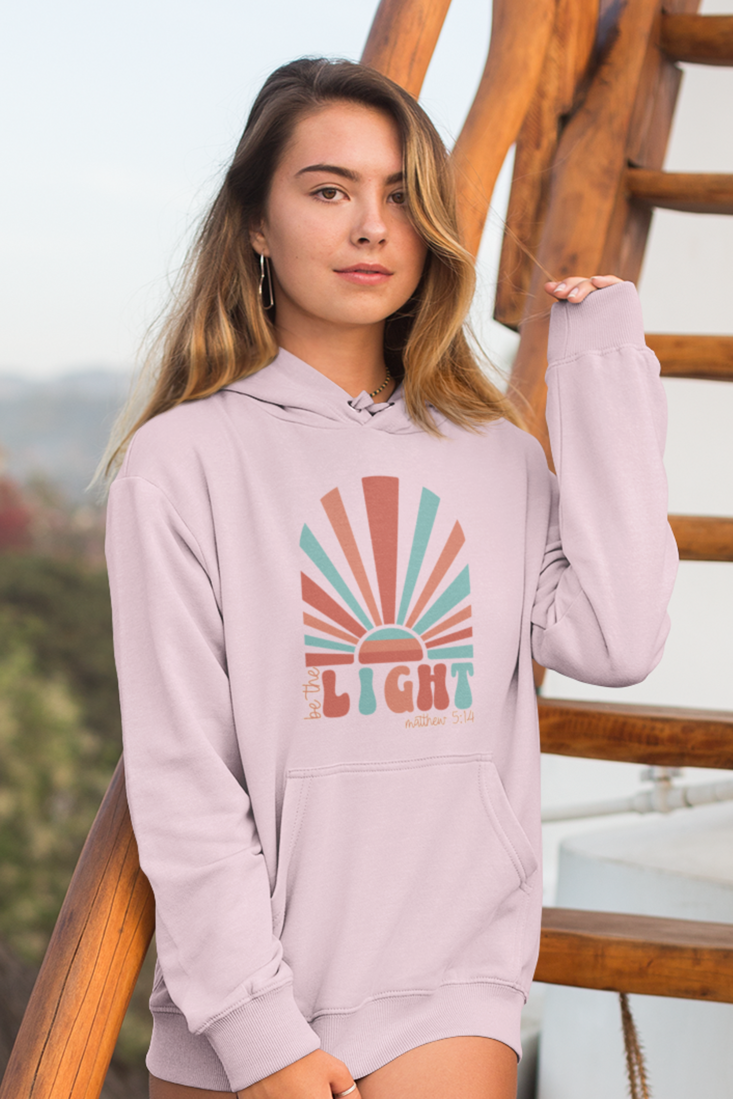 woman-in-beach-wearing-be-the-light-christain-hoodie-pink2