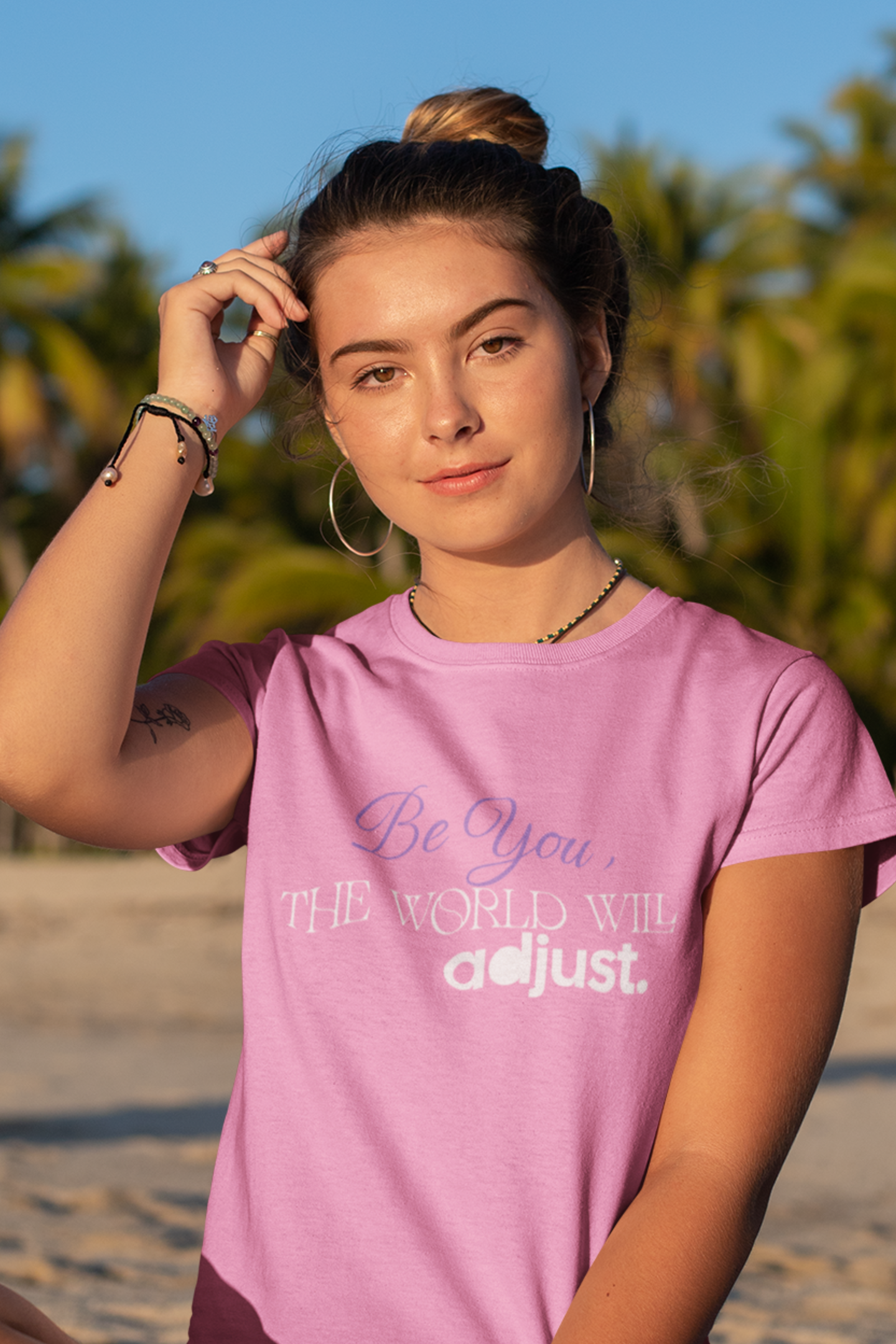 woman-in-beach-wearing-be-you-the-world-will-adjust-tee-azalea