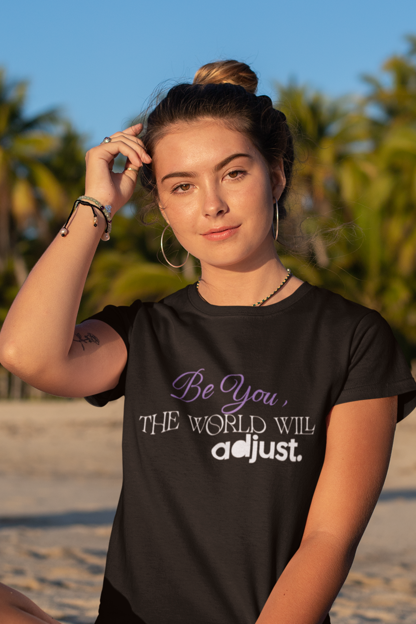 woman-in-beach-wearing-be-you-the-world-will-adjust-tee-black
