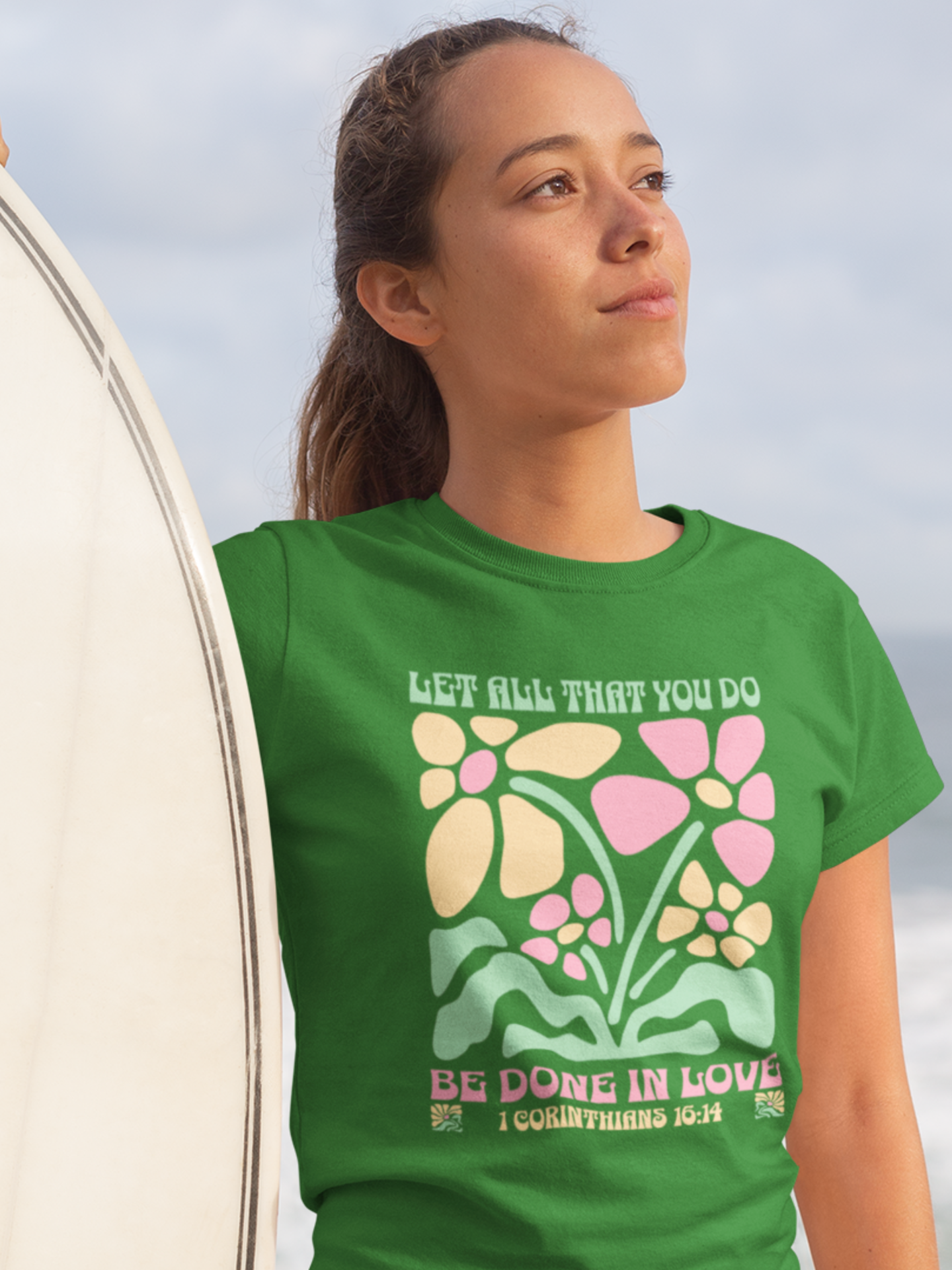 woman-in-beach-with-surfboard-wearing-christian-tee-irish-green
