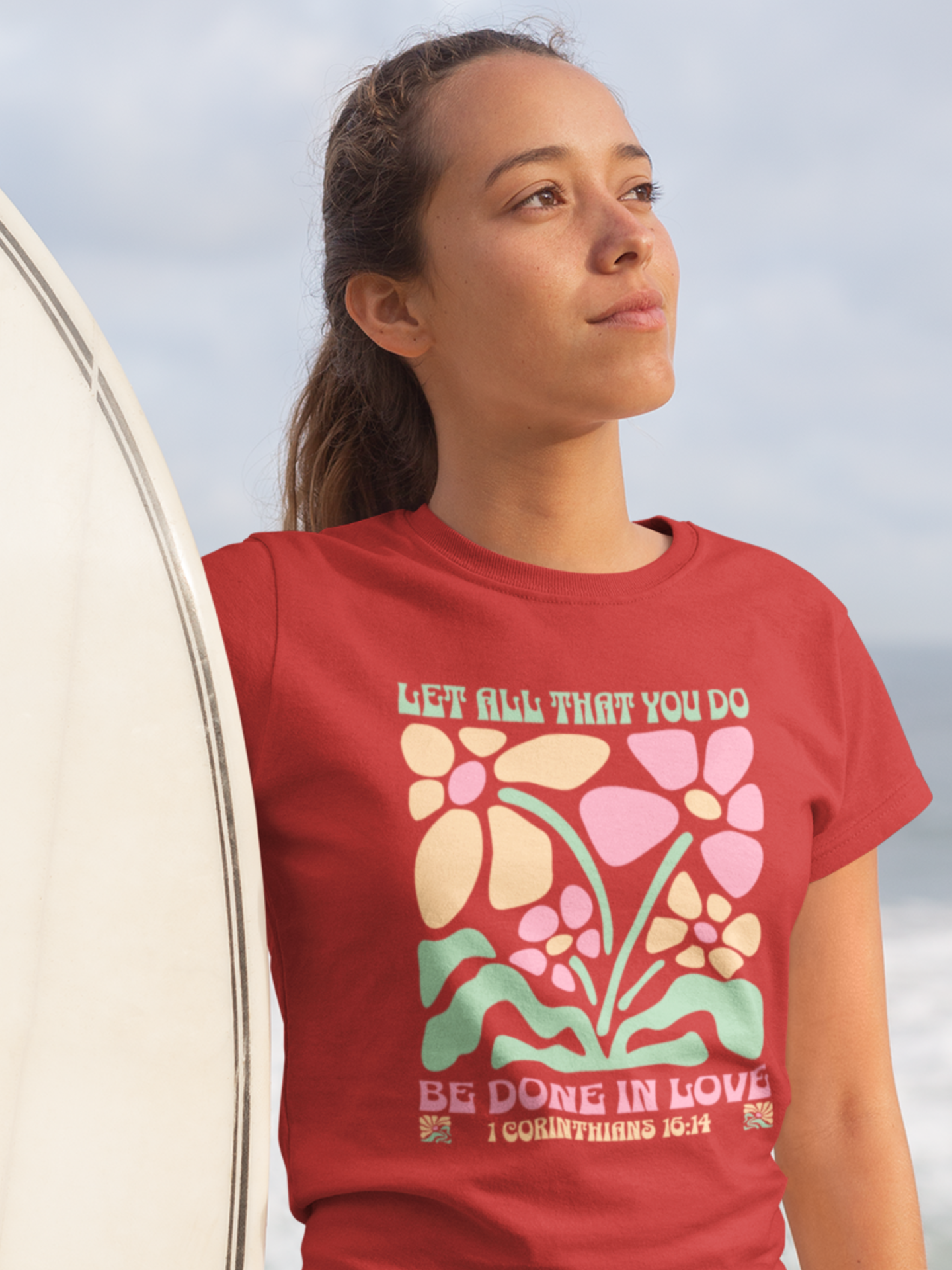 woman-in-beach-with-surfboard-wearing-christian-tee-red