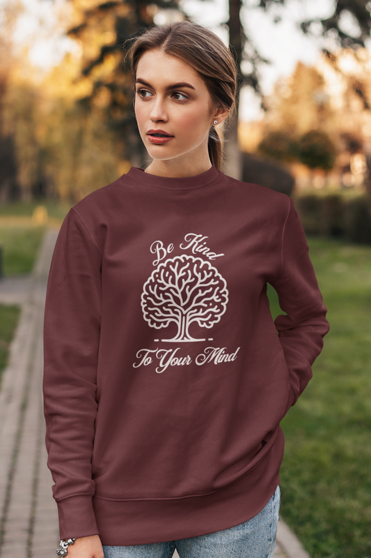 crewneck-sweatshirt-of-a-serious-woman-posing-in-a-garden-wearing-be-kind-to-your-mind-shirt-maroon-woman