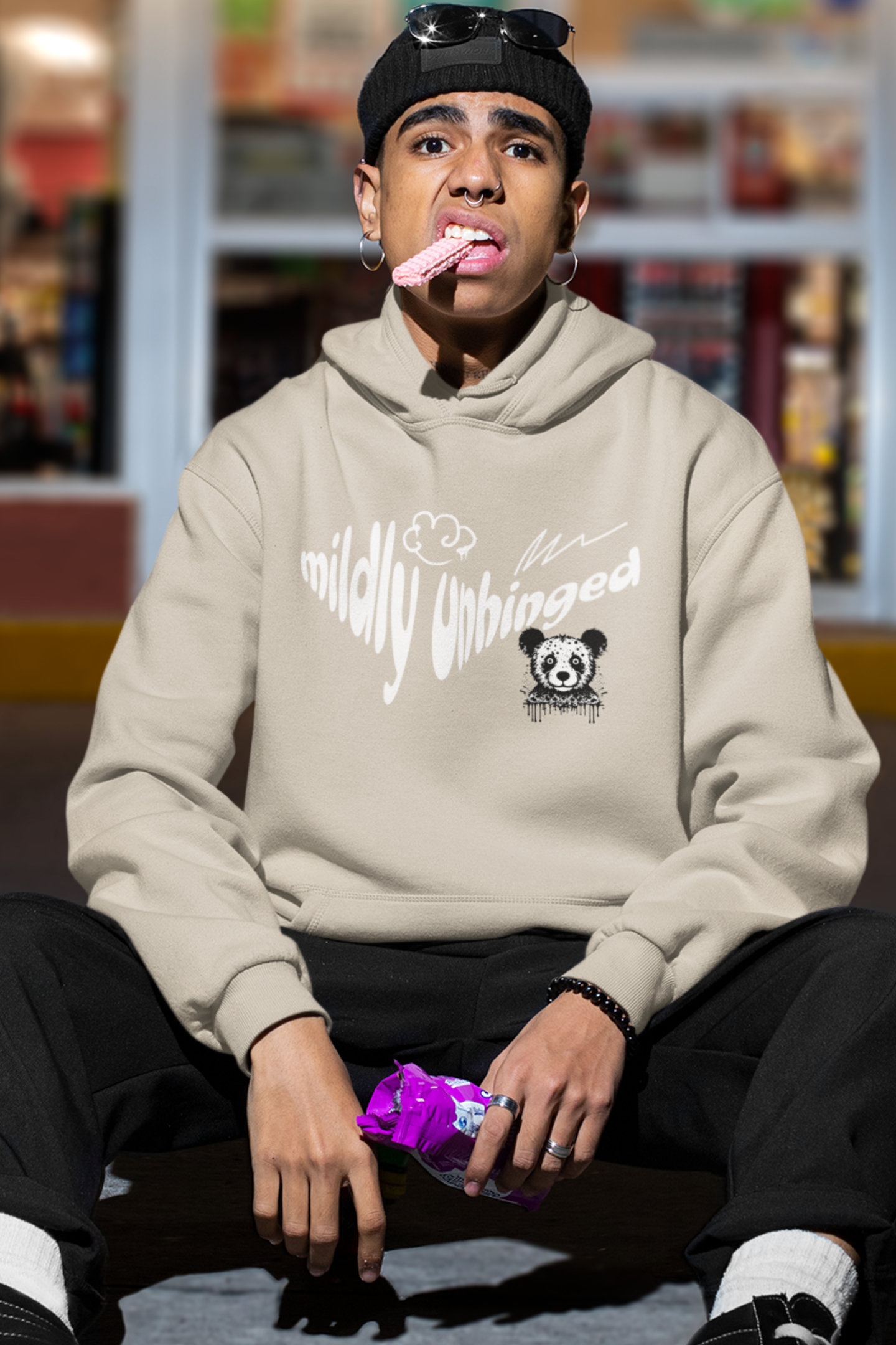 man-wearing-funny-hoodie-that-says-mildly-unhinged-sand