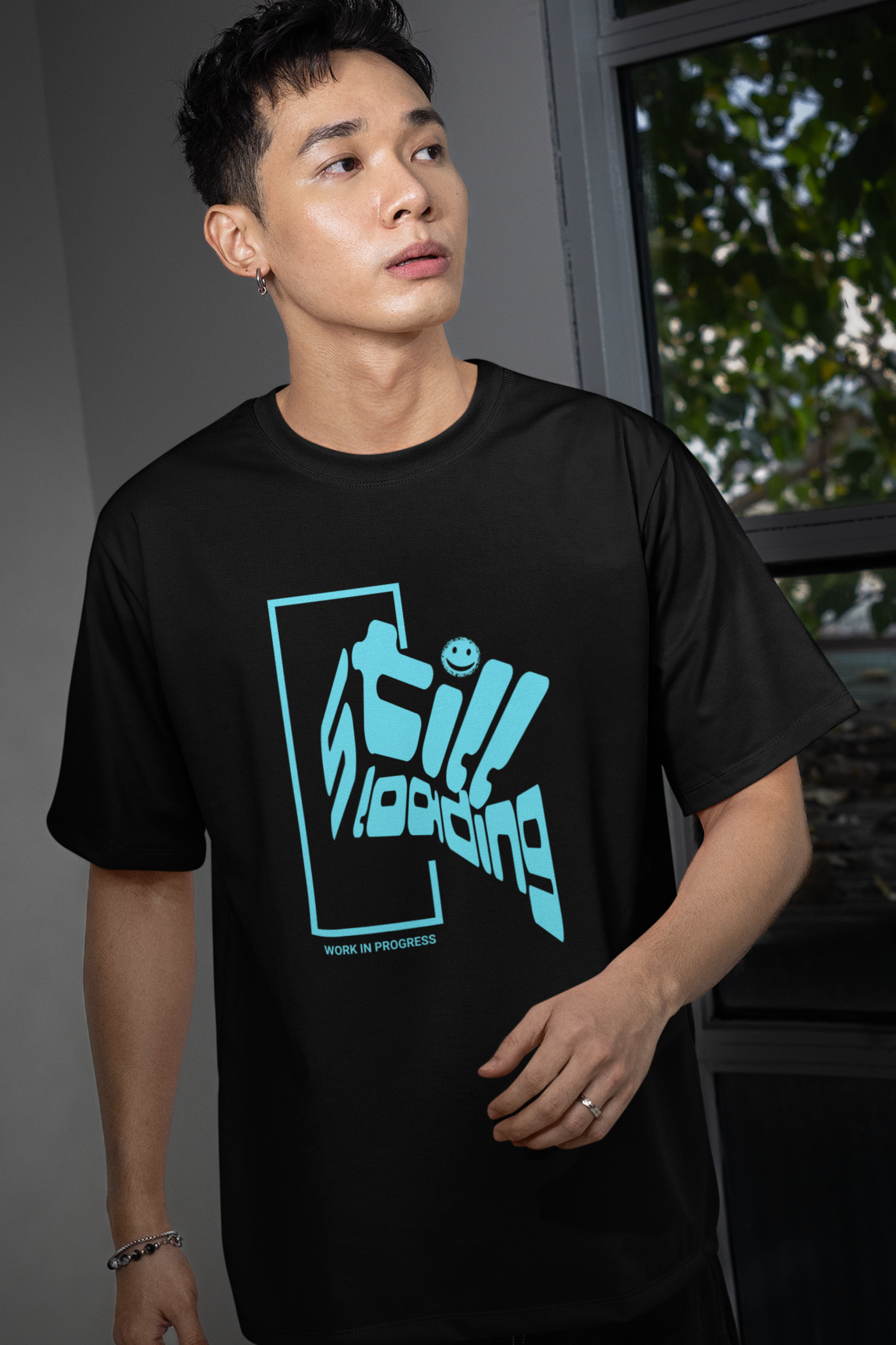 man-wearing-t-shirt-with-graphic-design-says-still-loading-color-black