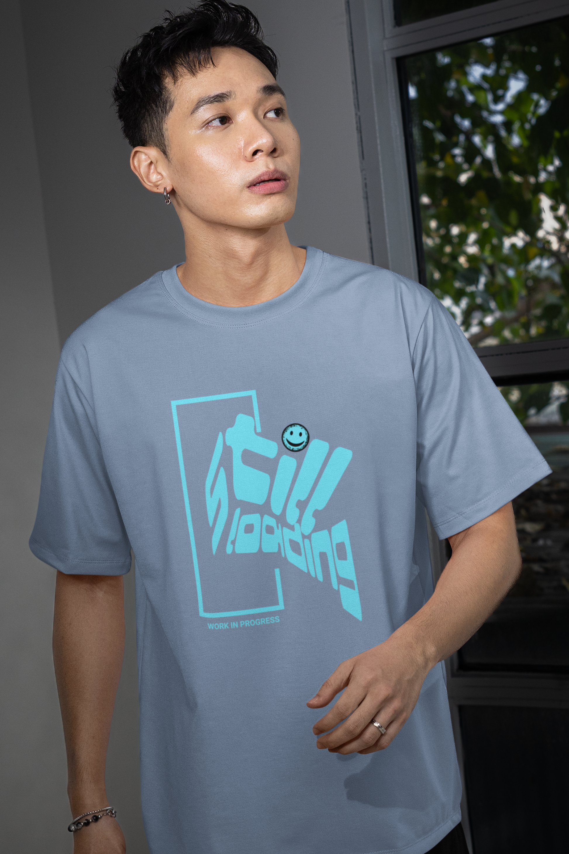 man-wearing-t-shirt-with-graphic-design-says-still-loading-color-blue