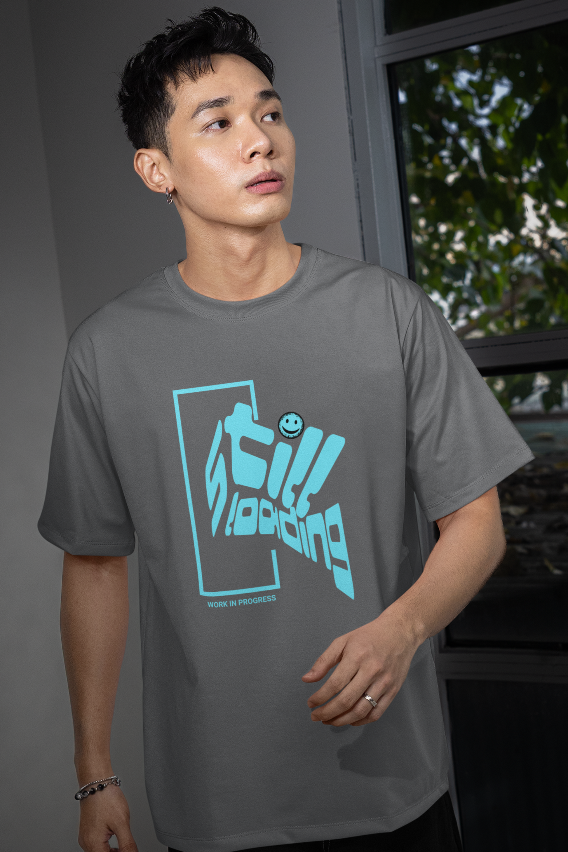 man-wearing-t-shirt-with-graphic-design-says-still-loading-color-gray