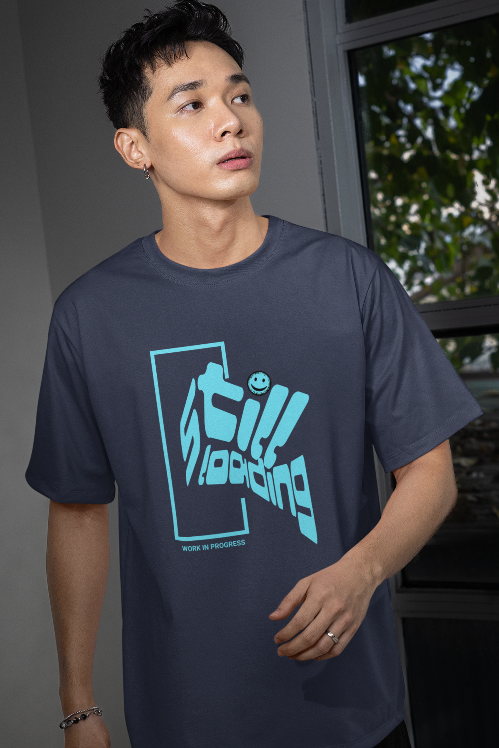 man-wearing-t-shirt-with-graphic-design-says-still-loading-color-navy