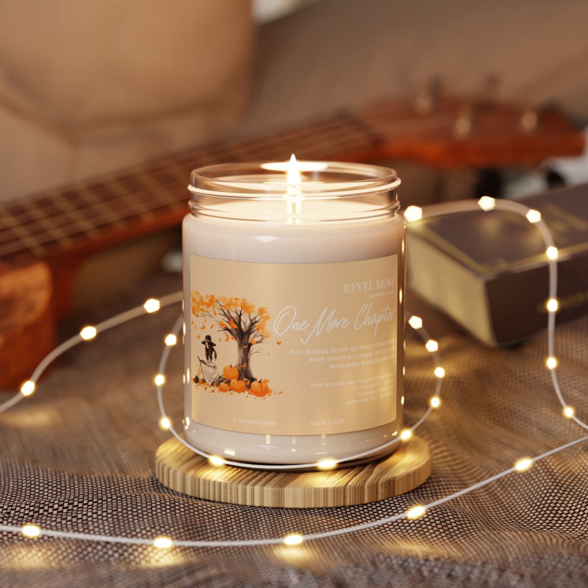 Candle in a glass jar with a wooden coaster on a surface with string lights and a guitar in the background