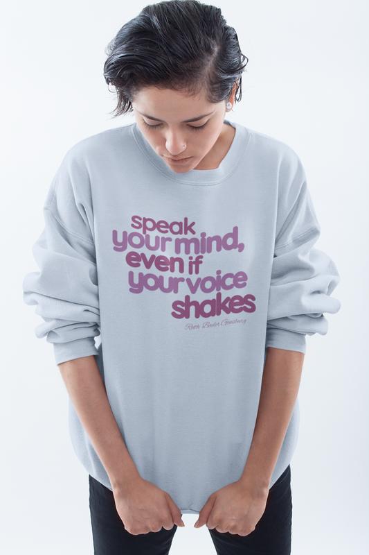 short-haired-woman-pulling-down-her-sweatshirt-wearing-women-empoowerment-shirt-blue