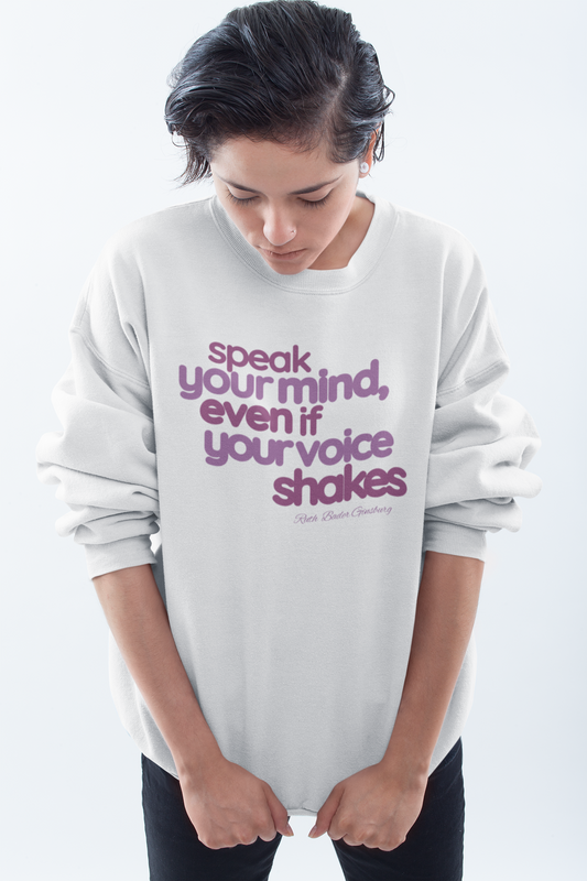 short-haired-woman-pulling-down-her-sweatshirt-wearing-women-empoowerment-shirt-white