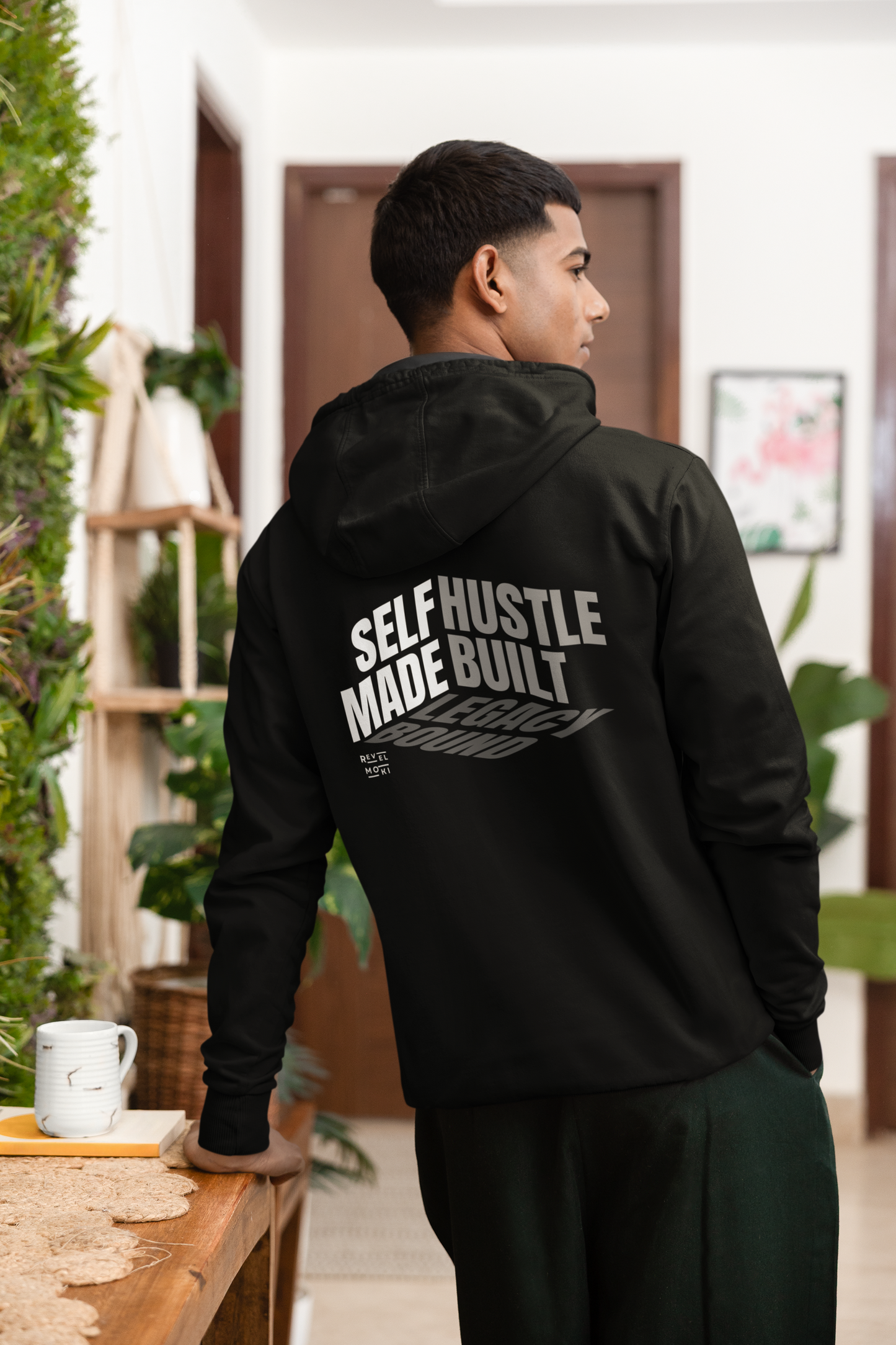 person-wearing-back-of-hoodie-says-self--made-hustle-built-legacy-bound-color-black