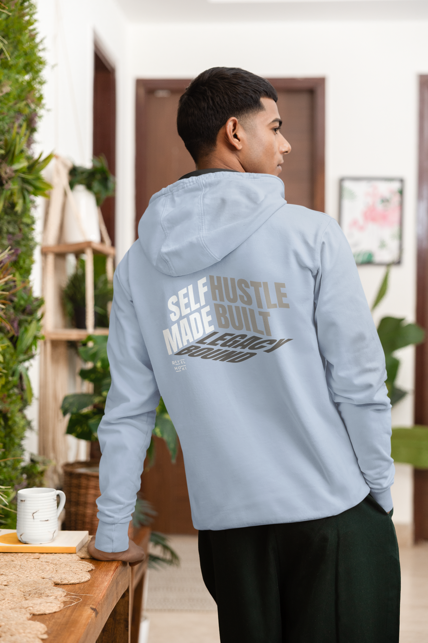 person-wearing-back-of-hoodie-says-self--made-hustle-built-legacy-bound-color-blue