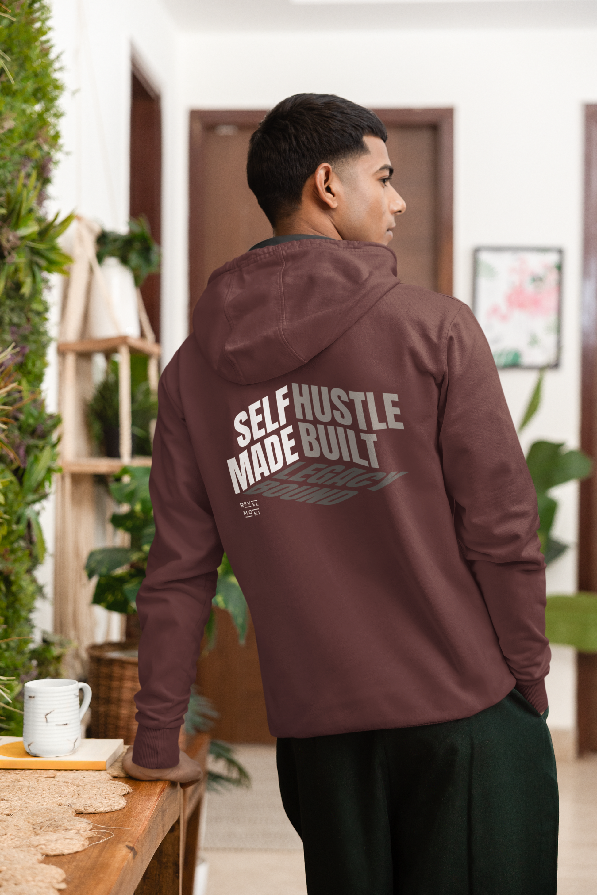 person-wearing-back-of-hoodie-says-self--made-hustle-built-legacy-bound-color-maroon
