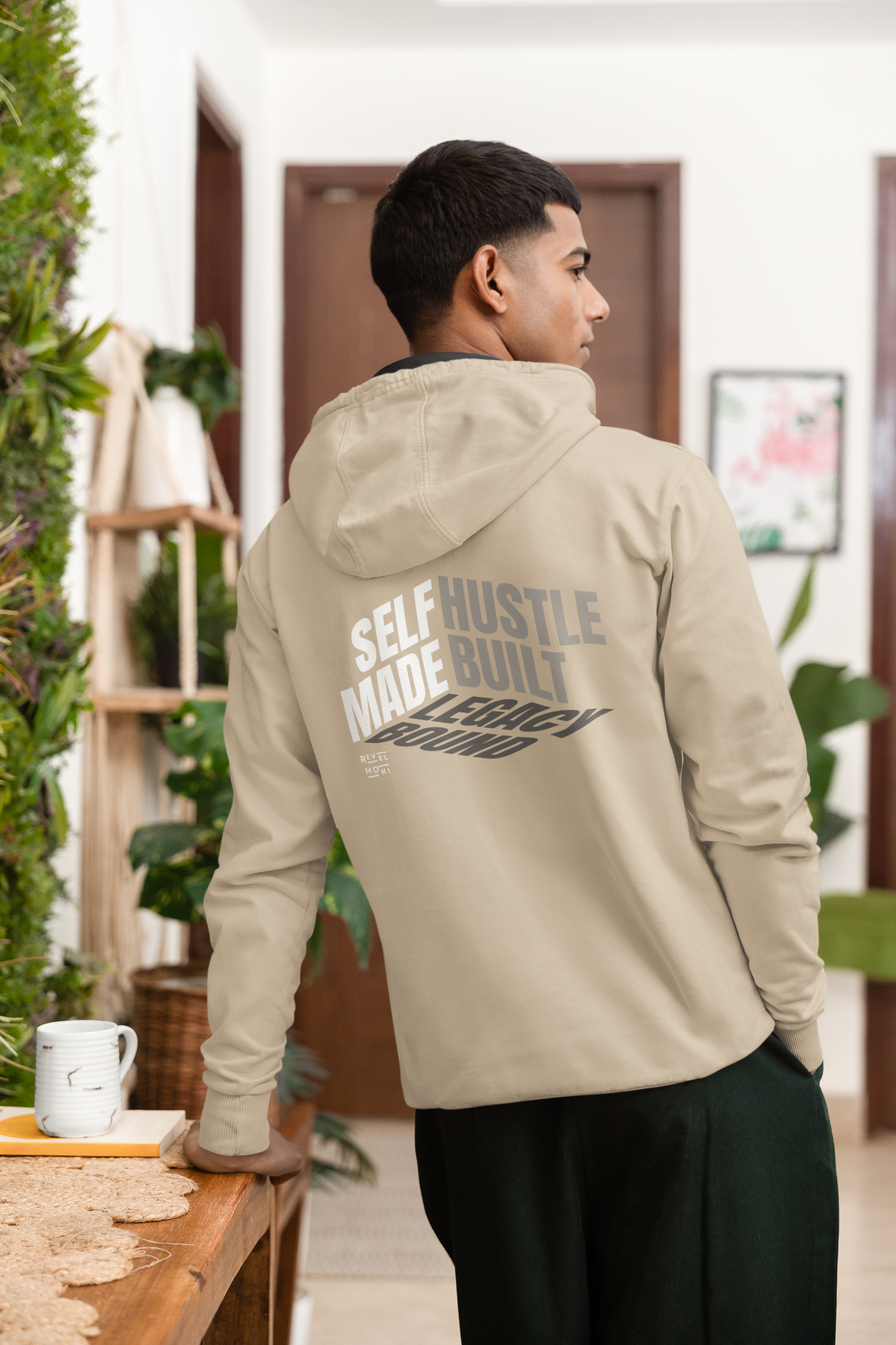 person-wearing-back-of-hoodie-says-self--made-hustle-built-legacy-bound-color-sand