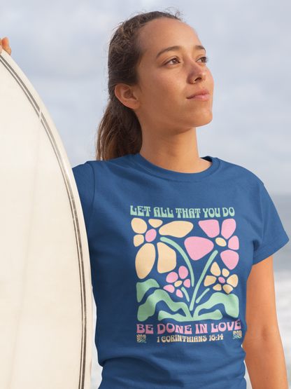 woman-in-beach-with-surfboard-wearing-christian-tee-royal